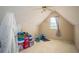 Finished attic space with carpet and window at 1511 Rocky Knoll Ln, Dacula, GA 30019