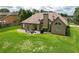 Aerial view of backyard with patio, lush lawn, and mature trees providing a private and serene outdoor setting at 1511 Rocky Knoll Ln, Dacula, GA 30019