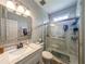 Bathroom featuring white marbled walk-in shower with glass door and coordinating vanity at 1511 Rocky Knoll Ln, Dacula, GA 30019