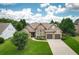 Charming home featuring a well-manicured lawn, stone accents, and an attached two-car garage at 1511 Rocky Knoll Ln, Dacula, GA 30019