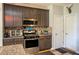Well-equipped kitchen with stainless steel appliances, granite counters, and ample cabinetry at 1511 Rocky Knoll Ln, Dacula, GA 30019