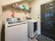 Functional laundry room featuring a washer, dryer, and storage shelves for organization at 1511 Rocky Knoll Ln, Dacula, GA 30019