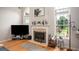 Bright living room featuring a fireplace, large windows, and stylish decor accents at 1511 Rocky Knoll Ln, Dacula, GA 30019