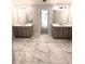Bathroom with double vanity, white marble floors, and modern fixtures at 3065 Zodiac Ct, Lawrenceville, GA 30044