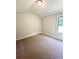 Bedroom features light beige walls, one window, carpet flooring, and modern light fixture at 3065 Zodiac Ct, Lawrenceville, GA 30044