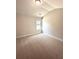 Bedroom features light beige walls, one window, carpet flooring, and modern light fixture at 3065 Zodiac Ct, Lawrenceville, GA 30044