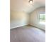 Cozy bedroom featuring neutral-colored walls, carpet, and a large window for natural light at 3065 Zodiac Ct, Lawrenceville, GA 30044