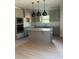 Modern kitchen featuring gray cabinets, granite countertops, a kitchen island, and stainless steel appliances at 3065 Zodiac Ct, Lawrenceville, GA 30044
