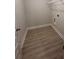 A convenient laundry room with a wire rack shelf and wood-look flooring at 3065 Zodiac Ct, Lawrenceville, GA 30044