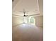 Spacious bedroom with a tray ceiling, carpet, and multiple windows for natural light at 3065 Zodiac Ct, Lawrenceville, GA 30044