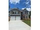 Charming two-story home featuring a two-car garage and stylish gray and brick facade at 746 Great Oak Pl, Villa Rica, GA 30180