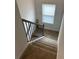 Carpeted staircase with a black railing and white trim, leading to the upper level at 746 Great Oak Pl, Villa Rica, GA 30180