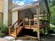 Back porch with a wooden railing and stairs leading down to a patio at 851 Millvale Pl, Lawrenceville, GA 30044