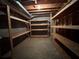 Unfinished basement space with wood shelving for storage and visible ductwork at 851 Millvale Pl, Lawrenceville, GA 30044