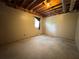 Unfinished basement with window, concrete floor, and exposed ceiling at 851 Millvale Pl, Lawrenceville, GA 30044