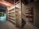 An unfinished basement, with shelving and a doorway, providing an opportunity for customization at 851 Millvale Pl, Lawrenceville, GA 30044