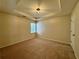 A serene bedroom featuring neutral tones, plush carpeting, and a modern ceiling light at 851 Millvale Pl, Lawrenceville, GA 30044