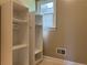 A closet with white shelving and storage options, illuminated by natural light from a nearby window at 851 Millvale Pl, Lawrenceville, GA 30044
