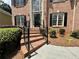 Brick steps with iron railing lead to the front door of this elegant home at 851 Millvale Pl, Lawrenceville, GA 30044