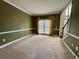 Spacious living room with neutral carpet, large windows, and decorative moldings at 851 Millvale Pl, Lawrenceville, GA 30044