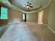 Spacious main bedroom with a ceiling fan, carpeted floors, and natural light from large windows at 851 Millvale Pl, Lawrenceville, GA 30044