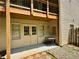 Outdoor patio with double doors, a table and chairs, and stone landscaping at 851 Millvale Pl, Lawrenceville, GA 30044