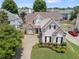Aerial view of a charming two-story home with stone accents and a well-manicured lawn at 1472 Lynchburg Pl, Marietta, GA 30062