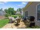 Outdoor flagstone patio features a built-in grill, with multiple seating areas and a lush lawn at 1472 Lynchburg Pl, Marietta, GA 30062