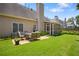 Spacious backyard featuring a stone patio with comfortable seating and a screened-in porch, perfect for entertaining at 1472 Lynchburg Pl, Marietta, GA 30062