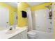 Bright, full bathroom featuring yellow walls, white tile, and a vanity with a sink at 1472 Lynchburg Pl, Marietta, GA 30062