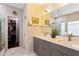 Bathroom featuring double sinks, walk-in closet, a shower with glass door, and a large mirror at 1472 Lynchburg Pl, Marietta, GA 30062