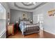Comfortable bedroom featuring a tray ceiling and an ensuite bathroom with double doors at 1472 Lynchburg Pl, Marietta, GA 30062