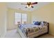 Relaxing bedroom features a ceiling fan, a window, and neutral carpet, perfect for a peaceful retreat at 1472 Lynchburg Pl, Marietta, GA 30062