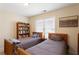 This bedroom has two beds and a bookshelf with a window providing natural light at 1472 Lynchburg Pl, Marietta, GA 30062