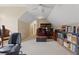 Spacious bonus room features neutral walls, carpet and a small desk, bookshelves, and office equipment at 1472 Lynchburg Pl, Marietta, GA 30062