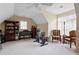 View of bonus room featuring neutral walls, carpet, a piano, treadmill and sitting area with chairs at 1472 Lynchburg Pl, Marietta, GA 30062