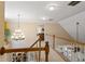 Upstairs hallway features beautiful chandelier and railing overlooking the dining room below at 1472 Lynchburg Pl, Marietta, GA 30062