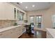Eat-in kitchen boasts stainless appliances, white cabinetry, granite counters, and access to the outdoor patio at 1472 Lynchburg Pl, Marietta, GA 30062