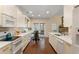 Bright kitchen features hardwood floors, white cabinets, modern appliances, and a breakfast area at 1472 Lynchburg Pl, Marietta, GA 30062