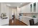 Modern kitchen featuring white cabinets, stone backsplash, and stainless steel appliances at 1472 Lynchburg Pl, Marietta, GA 30062