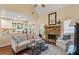 Cozy living room with stone fireplace and hardwood floors open to the kitchen area at 1472 Lynchburg Pl, Marietta, GA 30062