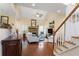 Bright living room with hardwood floors, stone fireplace, vaulted ceiling, and staircase at 1472 Lynchburg Pl, Marietta, GA 30062