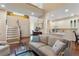 Open floor plan with hardwood floors and staircase leading upstairs, adjacent to the bright kitchen at 1472 Lynchburg Pl, Marietta, GA 30062