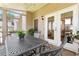 View of the screened-in porch featuring a ceiling fan, gray table with chairs, and a view of the backyard at 1472 Lynchburg Pl, Marietta, GA 30062