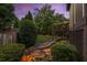 Backyard at twilight featuring a water feature and deck offers a serene outdoor living space at 1701 Clay Brooke Se Ct, Smyrna, GA 30082