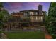 A lush backyard at twilight features a screened-in porch, an expansive deck, and a stone water feature at 1701 Clay Brooke Se Ct, Smyrna, GA 30082