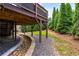 A view of the backyard and water feature running under the deck surrounded by lush greenery and professional landscaping at 1701 Clay Brooke Se Ct, Smyrna, GA 30082