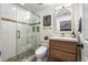 Modern bathroom featuring a glass enclosed shower with a neutral vanity and bright lighting and updated fixtures at 1701 Clay Brooke Se Ct, Smyrna, GA 30082