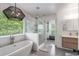 Elegant bathroom with a soaking tub, glass-enclosed shower, and modern fixtures at 1701 Clay Brooke Se Ct, Smyrna, GA 30082
