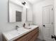 Well-lit bathroom with a double sink vanity, wood cabinets, and updated fixtures at 1701 Clay Brooke Se Ct, Smyrna, GA 30082